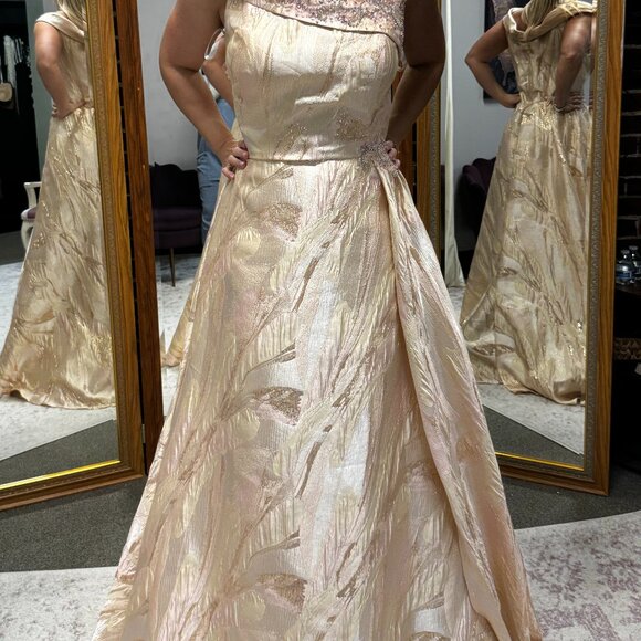Pink/gold off-shoulder brocade gown with side drape & beaded detail.